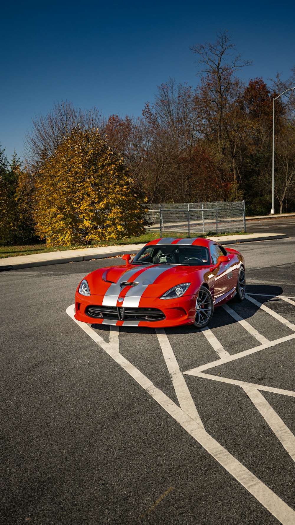 a red sports car parked in a parking lot