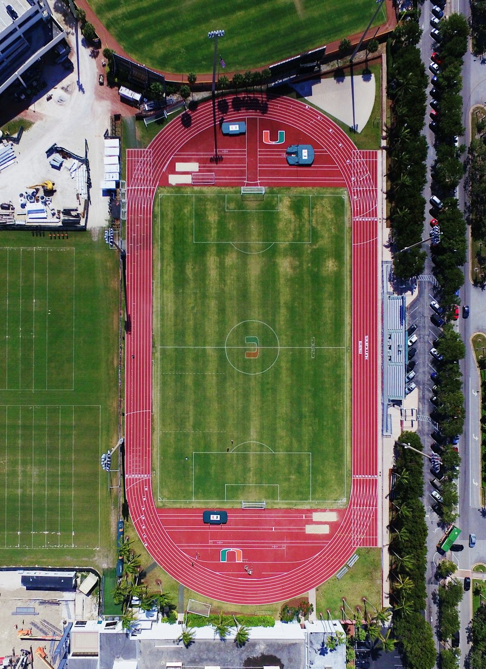 an aerial view of a stadium with a red track