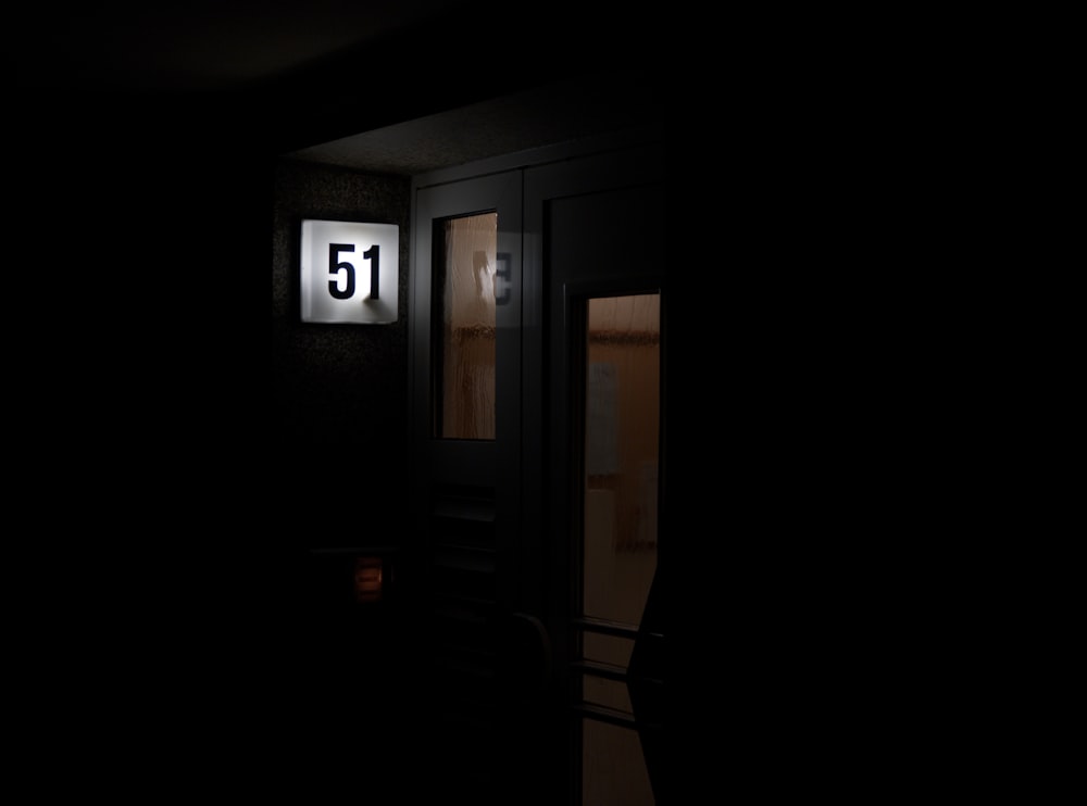 a dark room with a door that has a number 51 on it