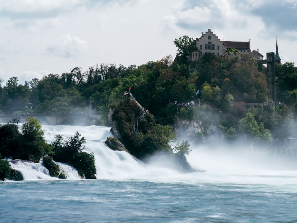 a castle sits on a small island in the middle of a river