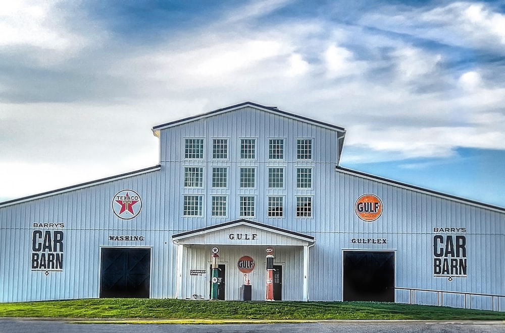 a large white building with cars on the side of it