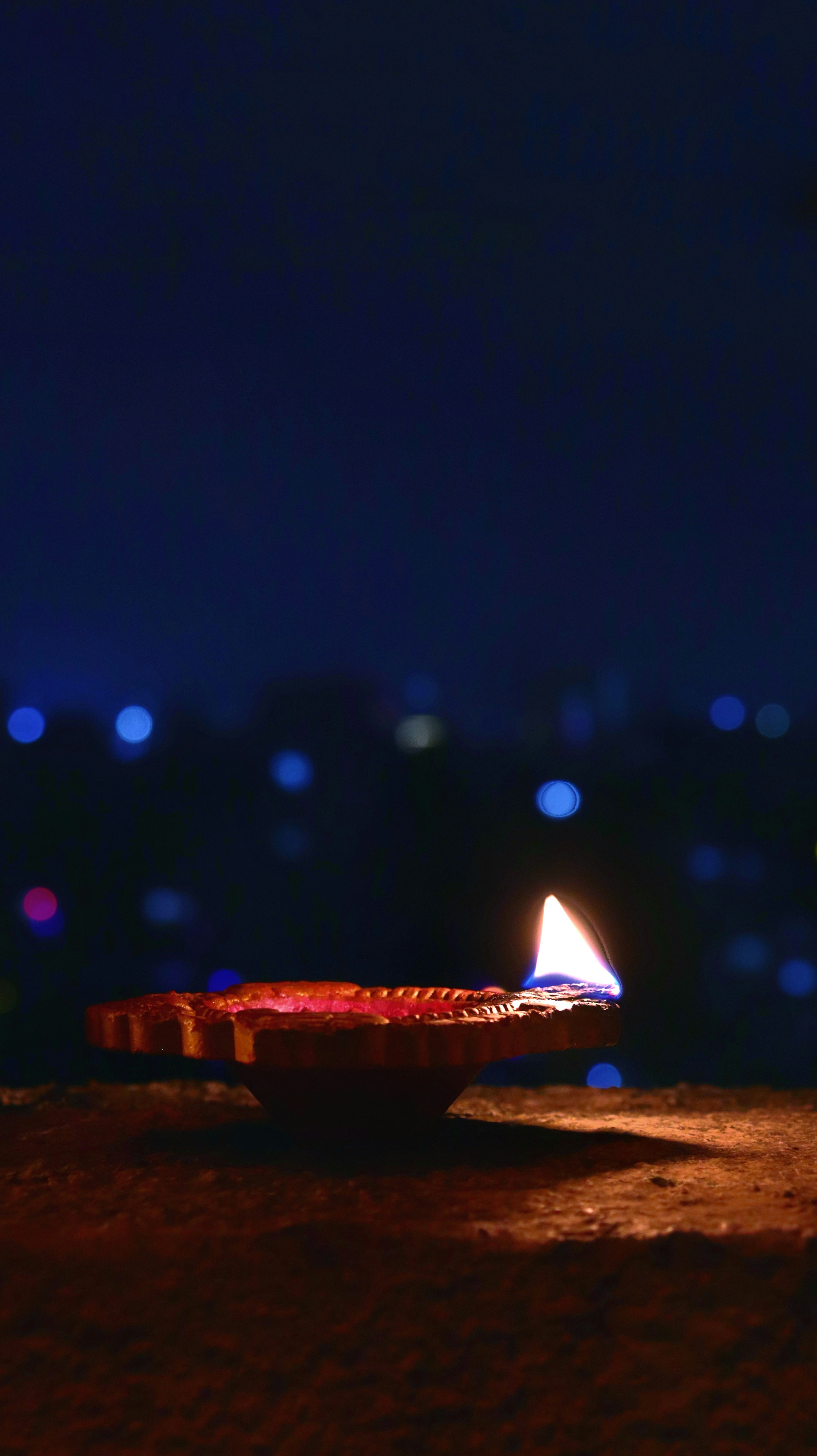 a lit candle sitting on top of a table