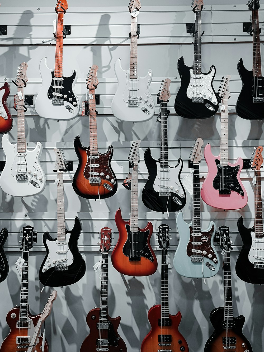 a group of guitars hanging on a wall