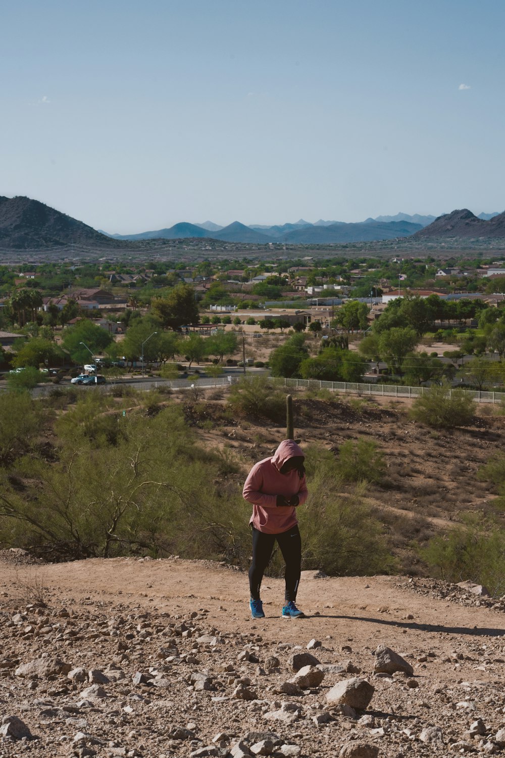 a person holding a baseball bat on top of a dirt field