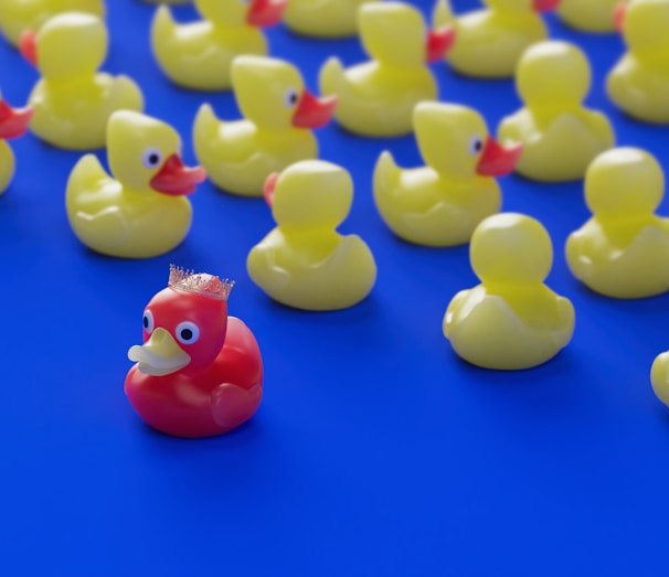 a bunch of rubber ducks sitting on a blue surface