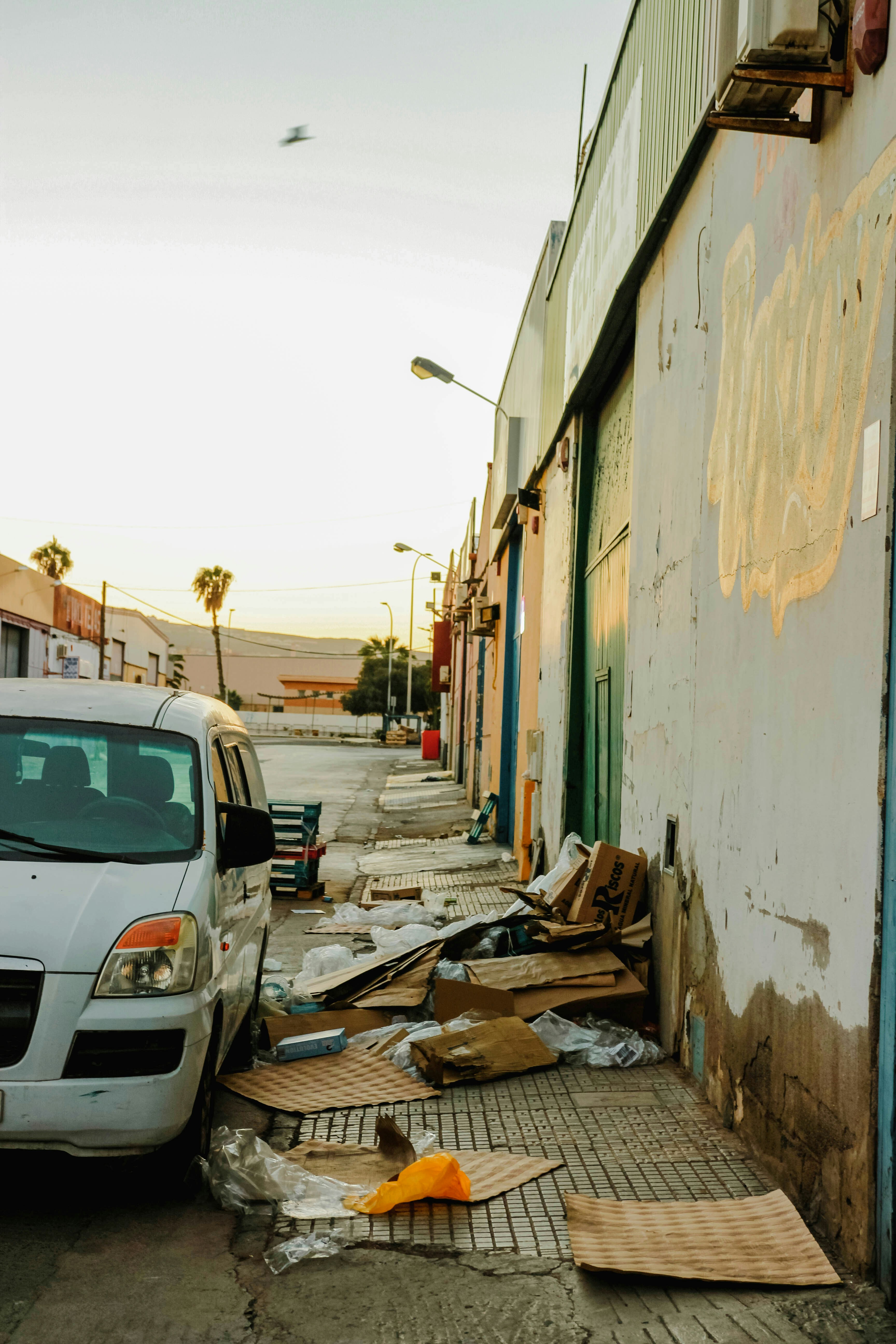 a car parked on the side of a road next to a building