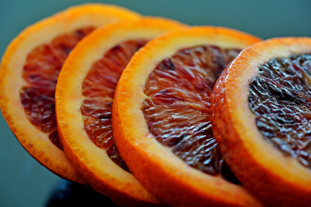 a close up of sliced blood oranges on a table