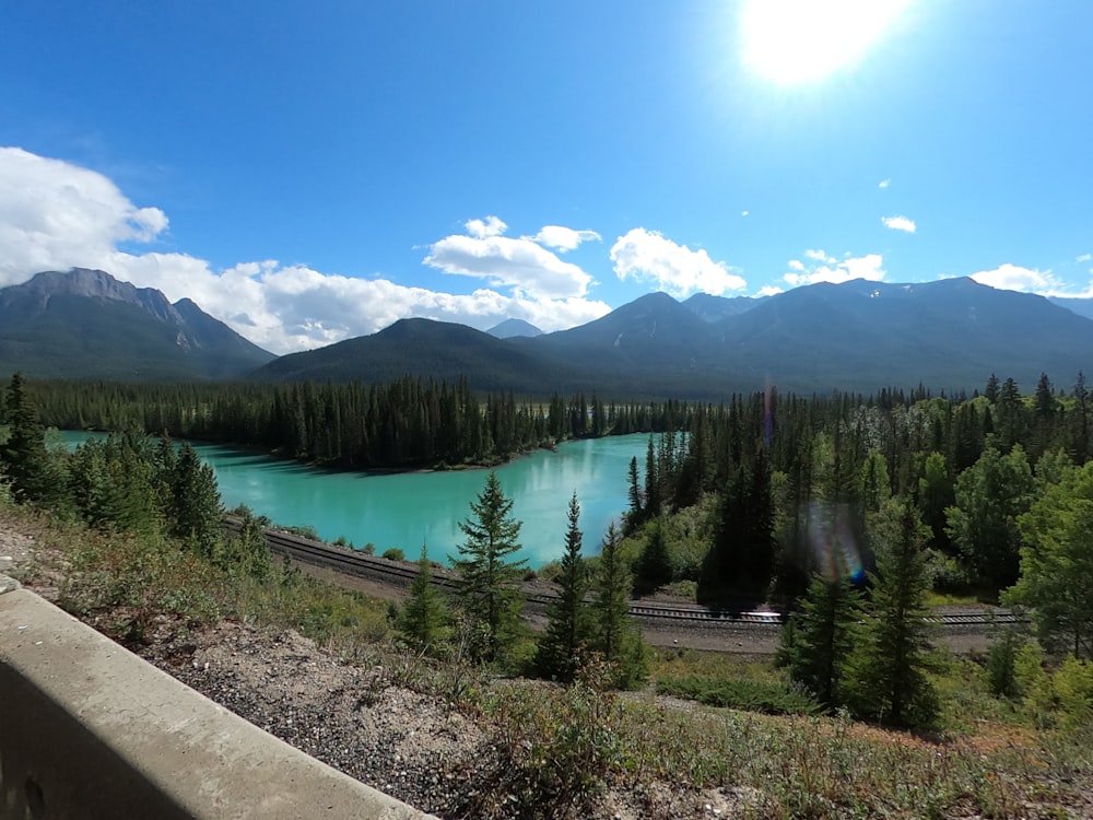 a scenic view of a lake surrounded by mountains