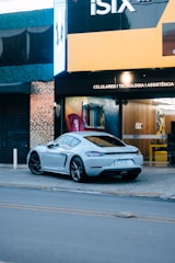 A sleek foreign car parked in front of the All Foreign Parts Inc. store.