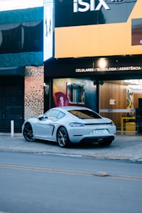 A sleek foreign car parked in front of the All Foreign Parts Inc. store.