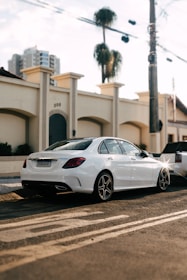 A private sedan cruising along a palm-lined street near the Prophet's Mosque in Madinah at sunset.
