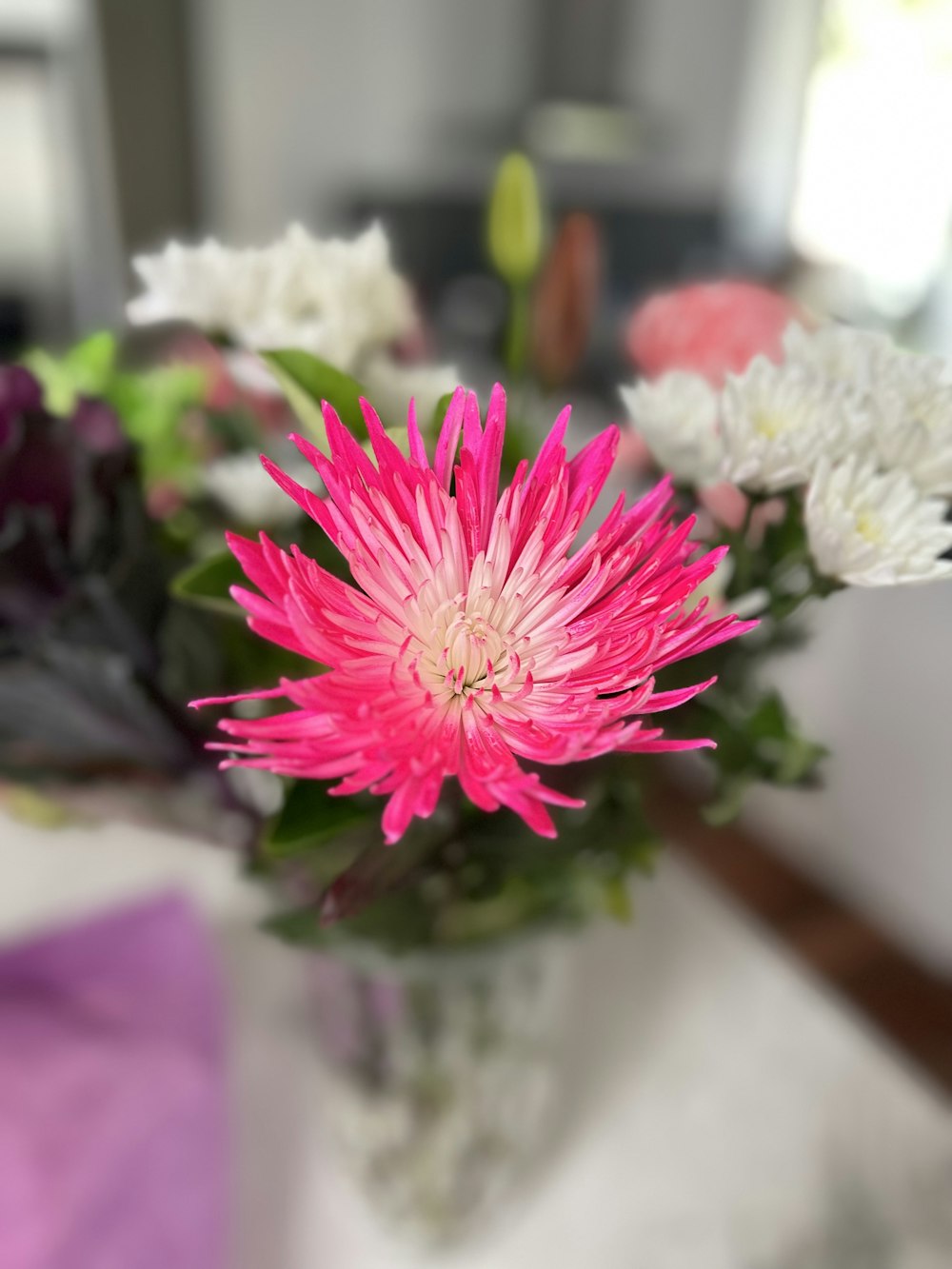 a vase filled with pink and white flowers