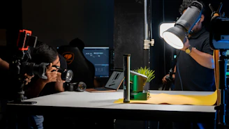 a man taking a picture of a green plant