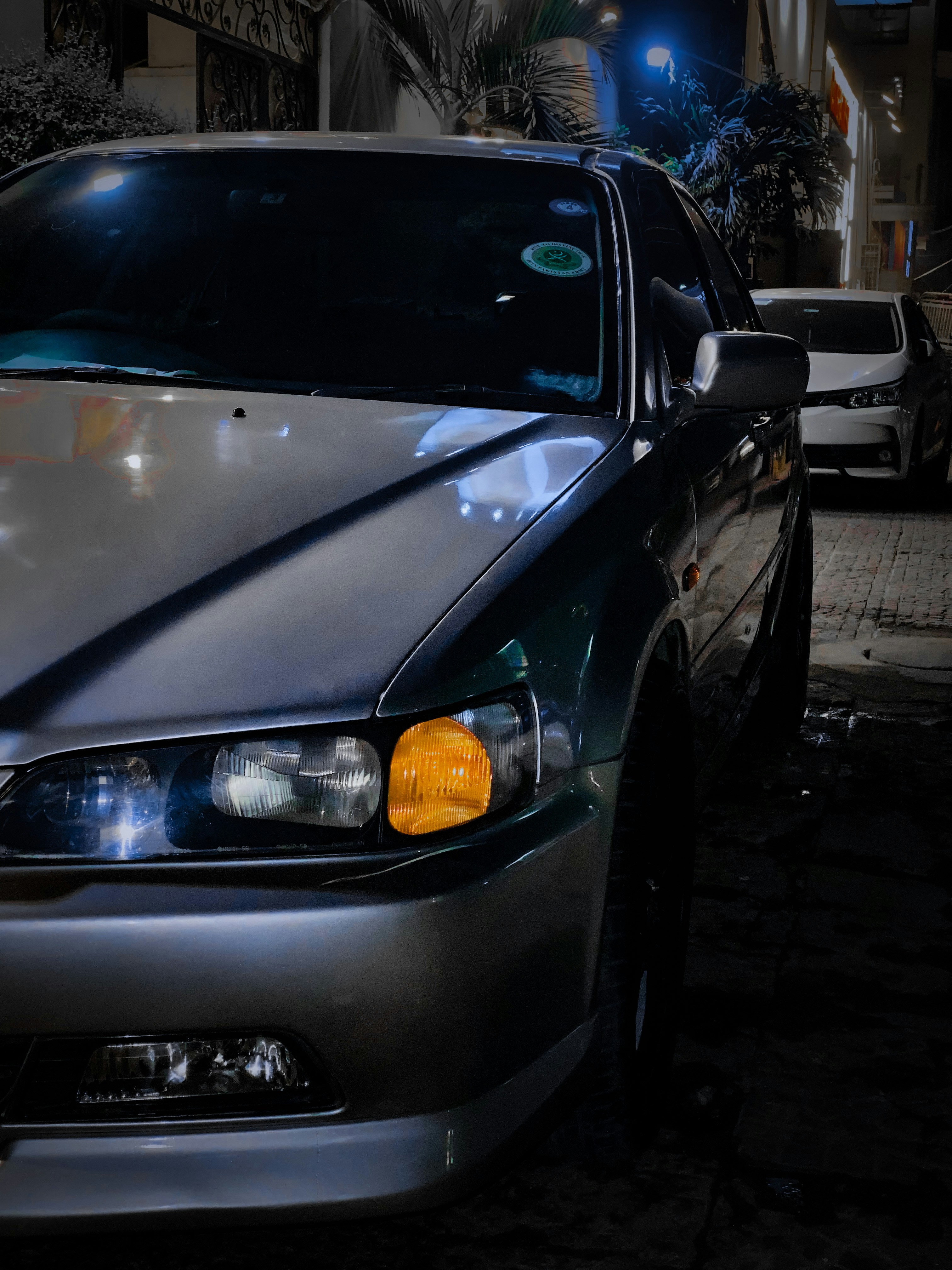 a silver car parked on the side of the road