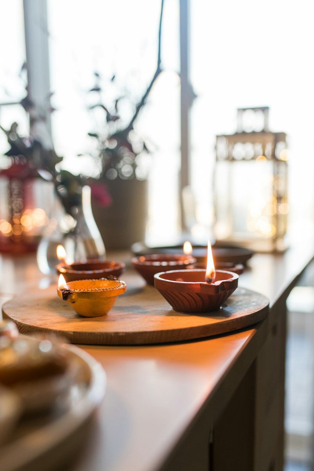 a wooden table topped with bowls filled with food