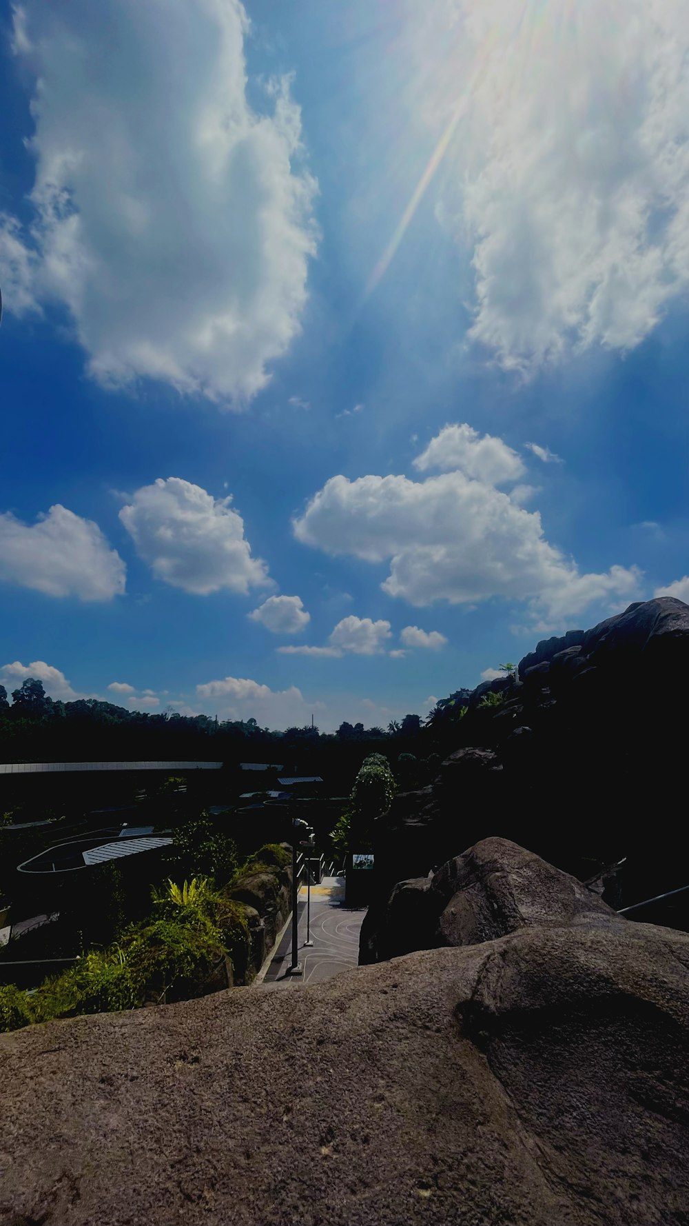 the sun shines brightly through the clouds above a park