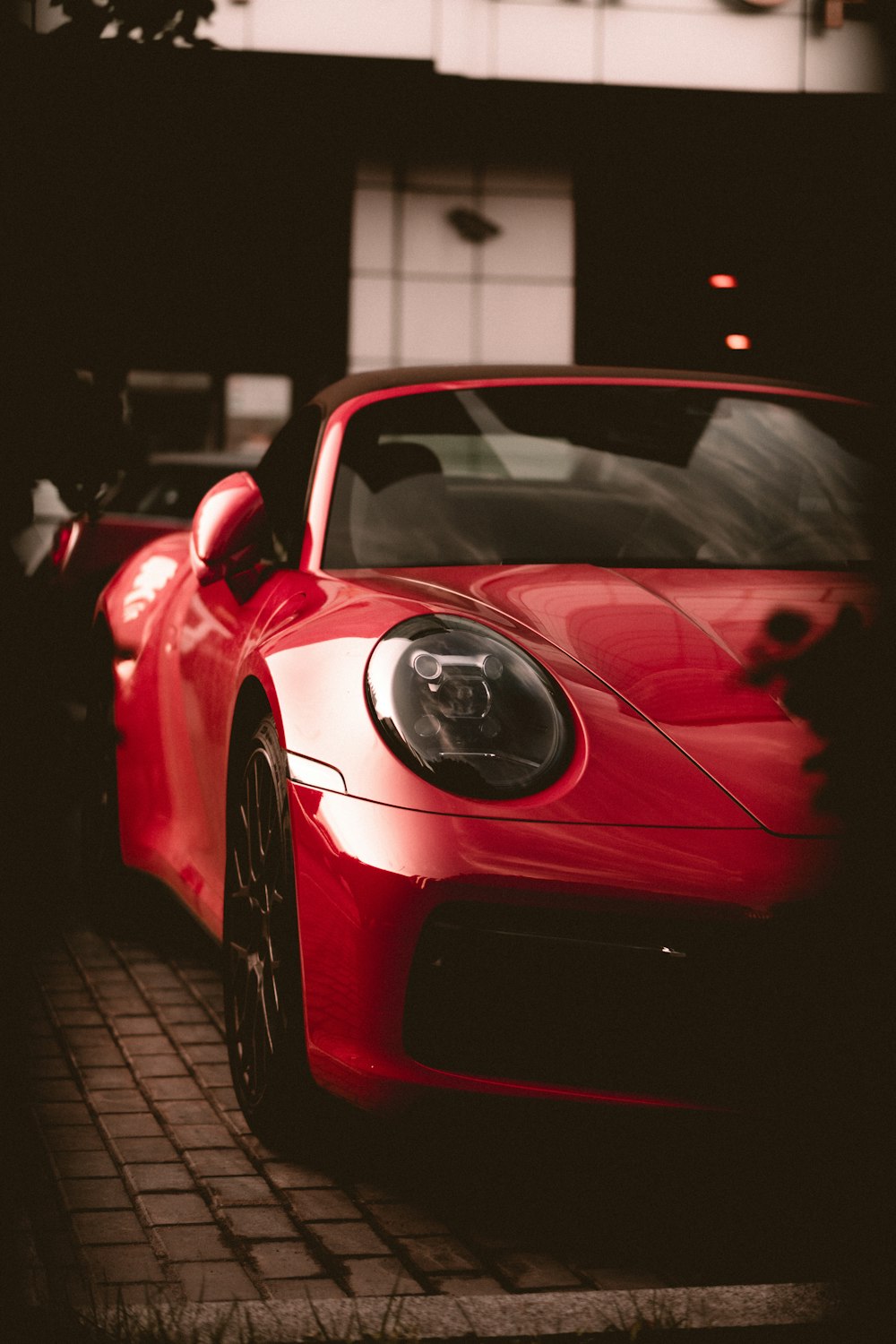 a red sports car parked in front of a building