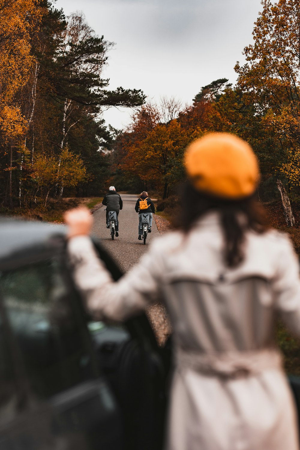 a couple of people riding motorcycles down a road