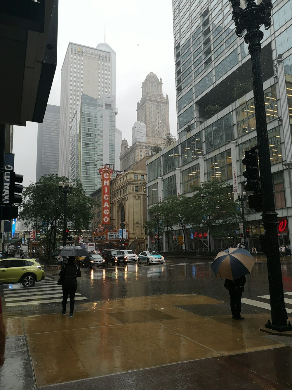 a couple of people with umbrellas on a city street