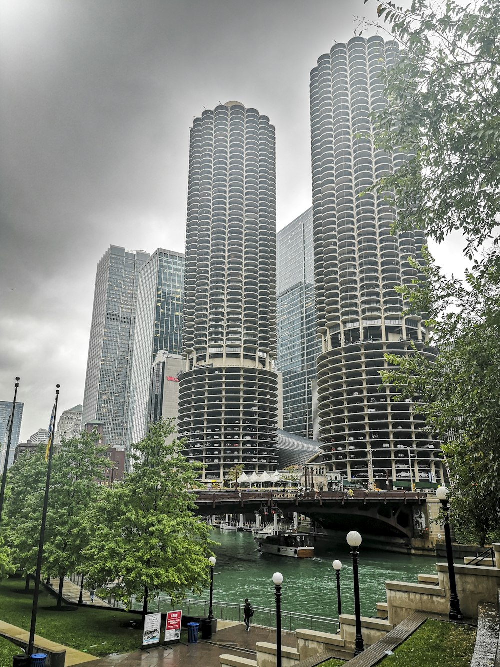 a couple of tall buildings sitting next to a river