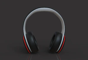A pair of wireless over-ear headphones with a matte black finish placed on a light gray background.