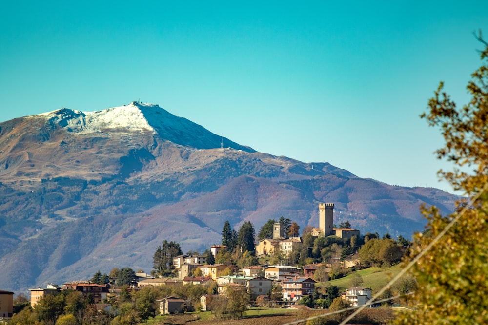 a view of a mountain with a village in the foreground