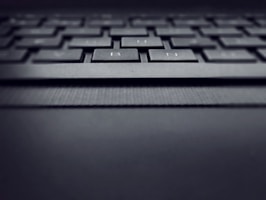 Close-up of a laptop keyboard with a focus on the keys and design details.