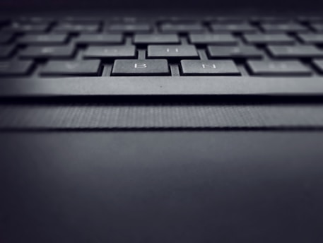 Close-up of a laptop keyboard with a focus on the keys and design details.
