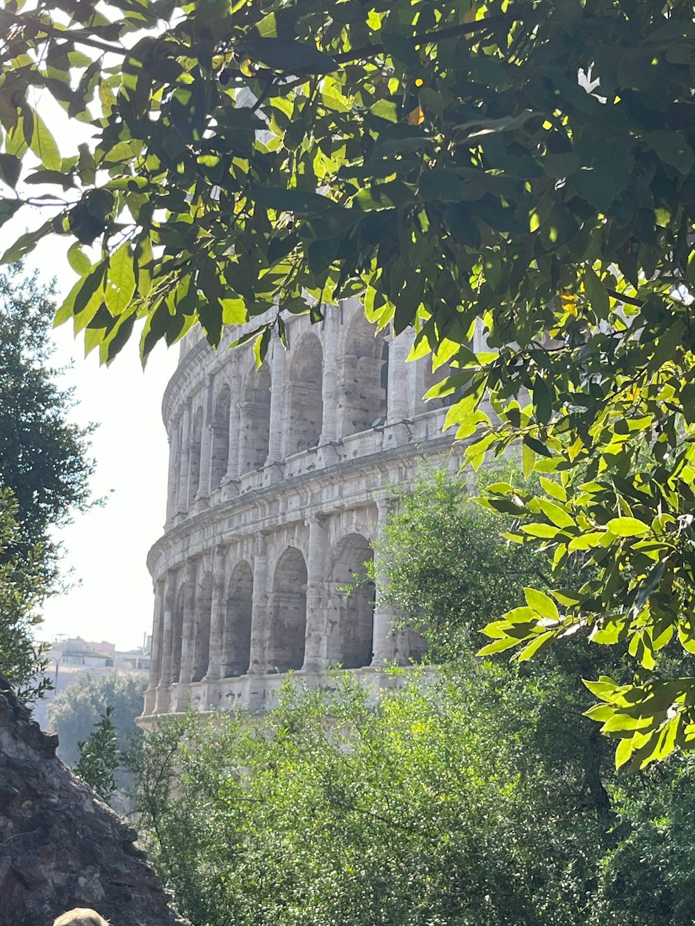 a woman sitting on a bench in front of an old building