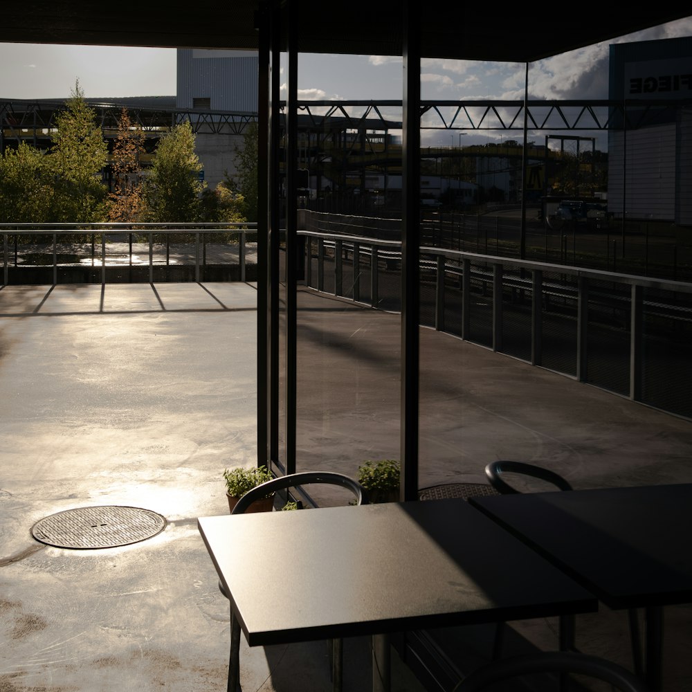 an empty patio with a table and chairs