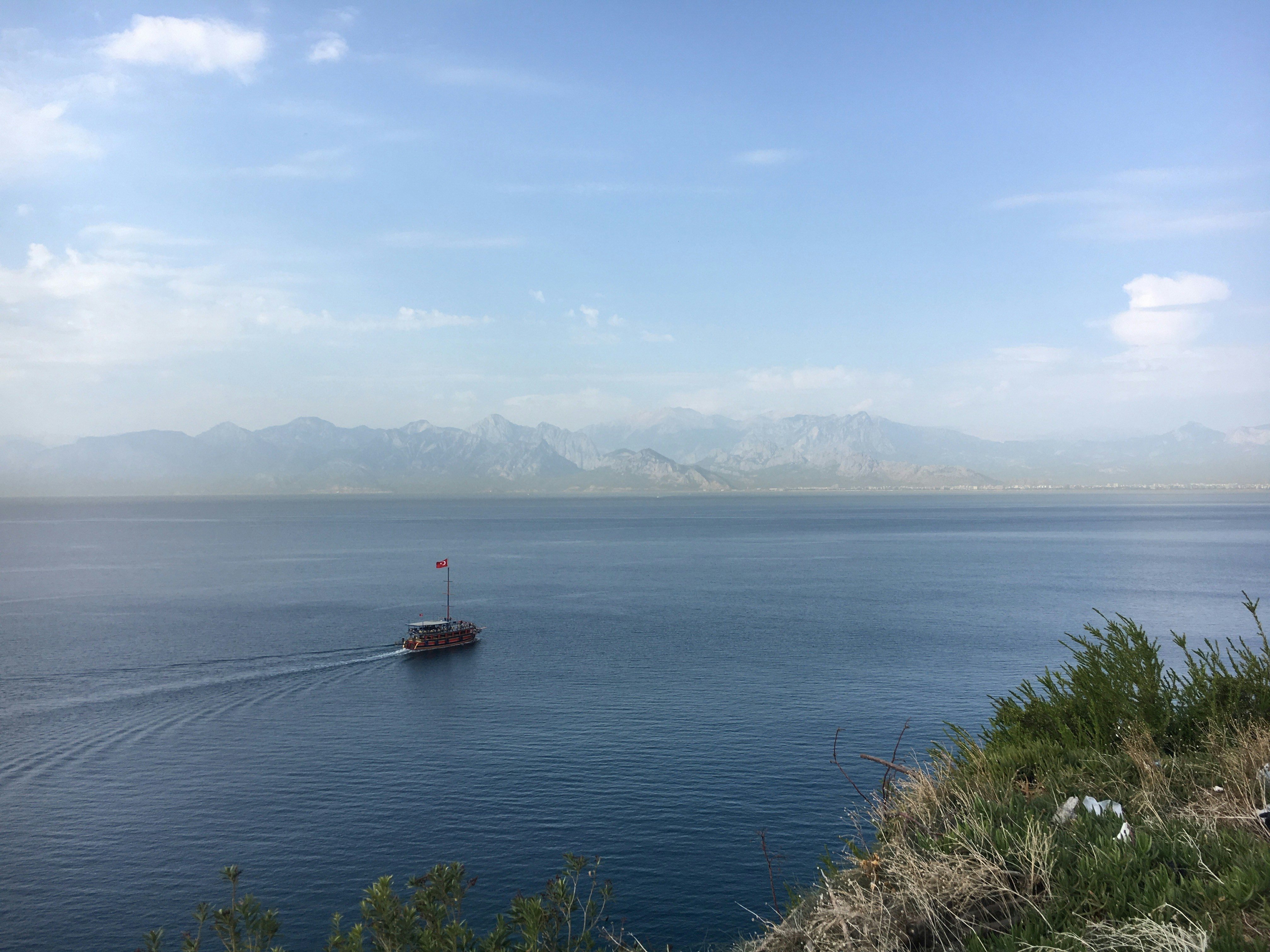 a boat traveling across a large body of water