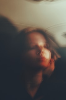 Soft focus portrait of a subject with natural expressions and muted colors