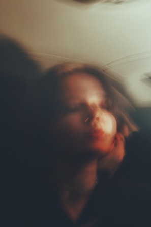 An artistic portrait capturing emotion with soft natural light.