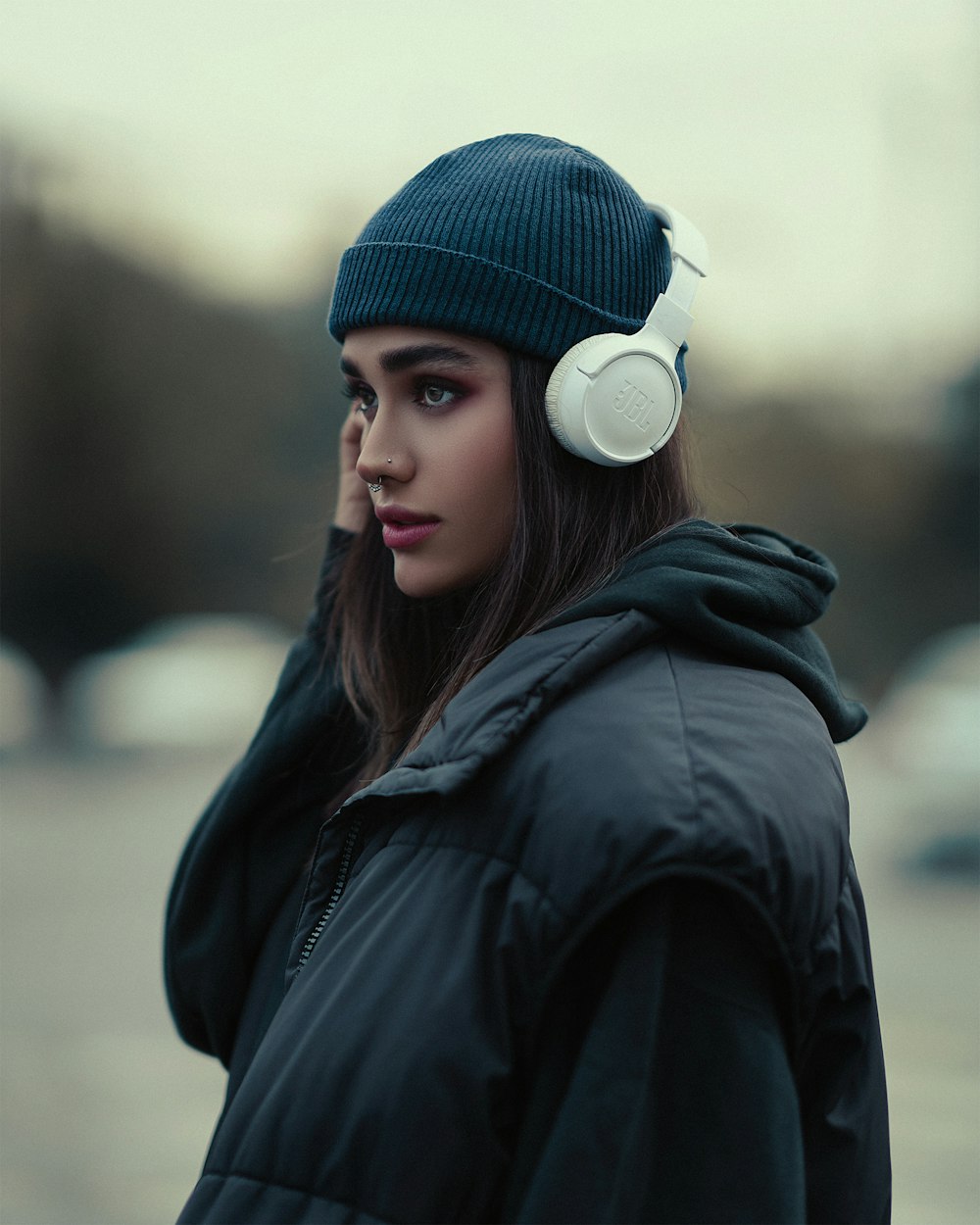 a woman wearing a beanie and headphones