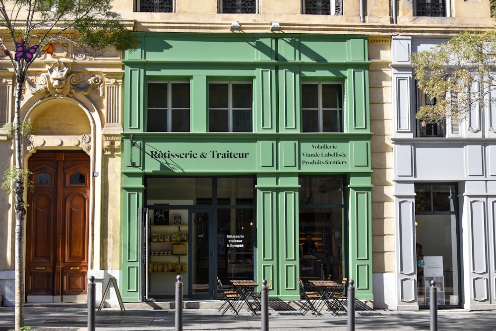 a building with a green front door and windows