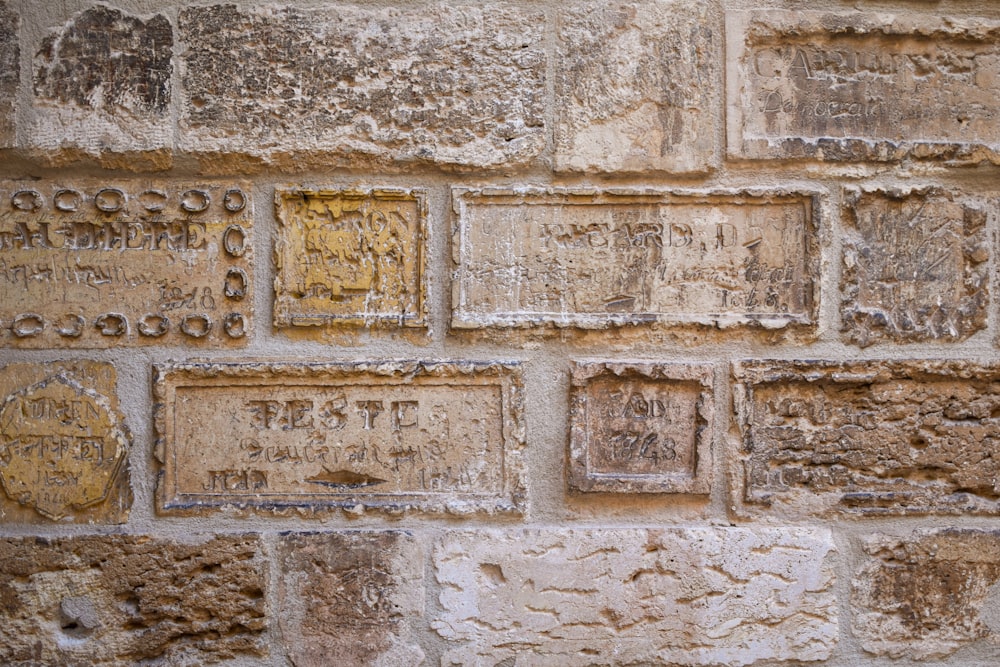 a brick wall that has some writing on it