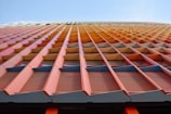 Close-up of sandwich panel installation on a commercial building facade with bright colors.