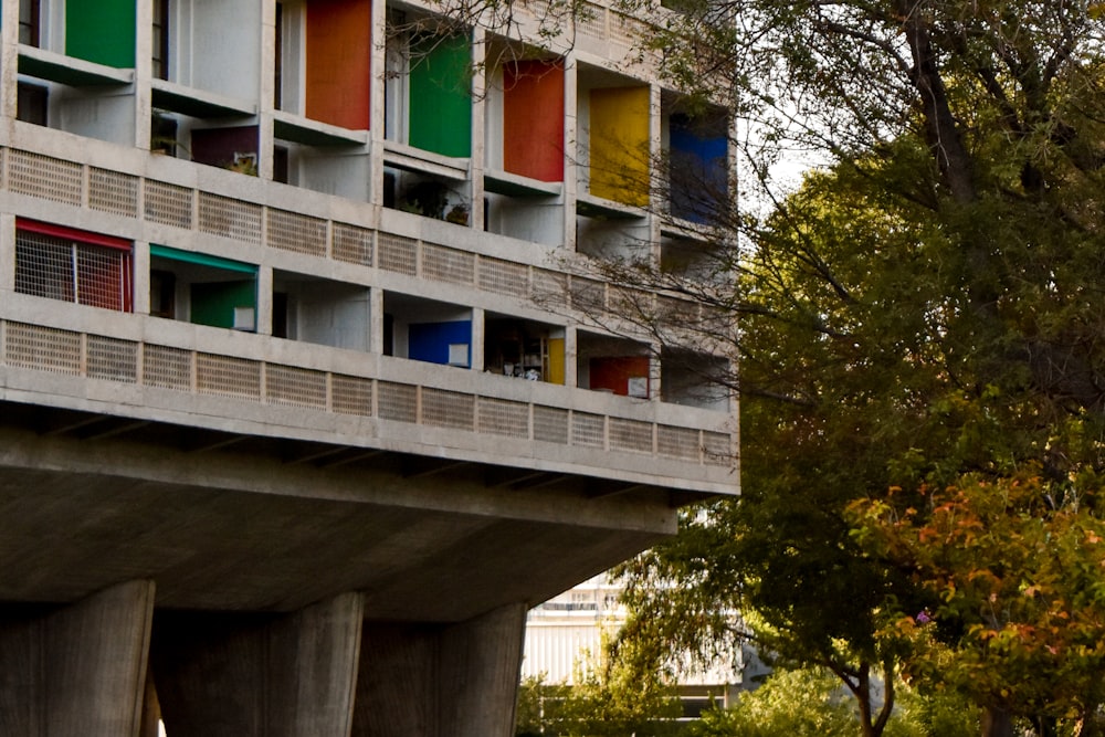 a tall building with colorful windows and balconies