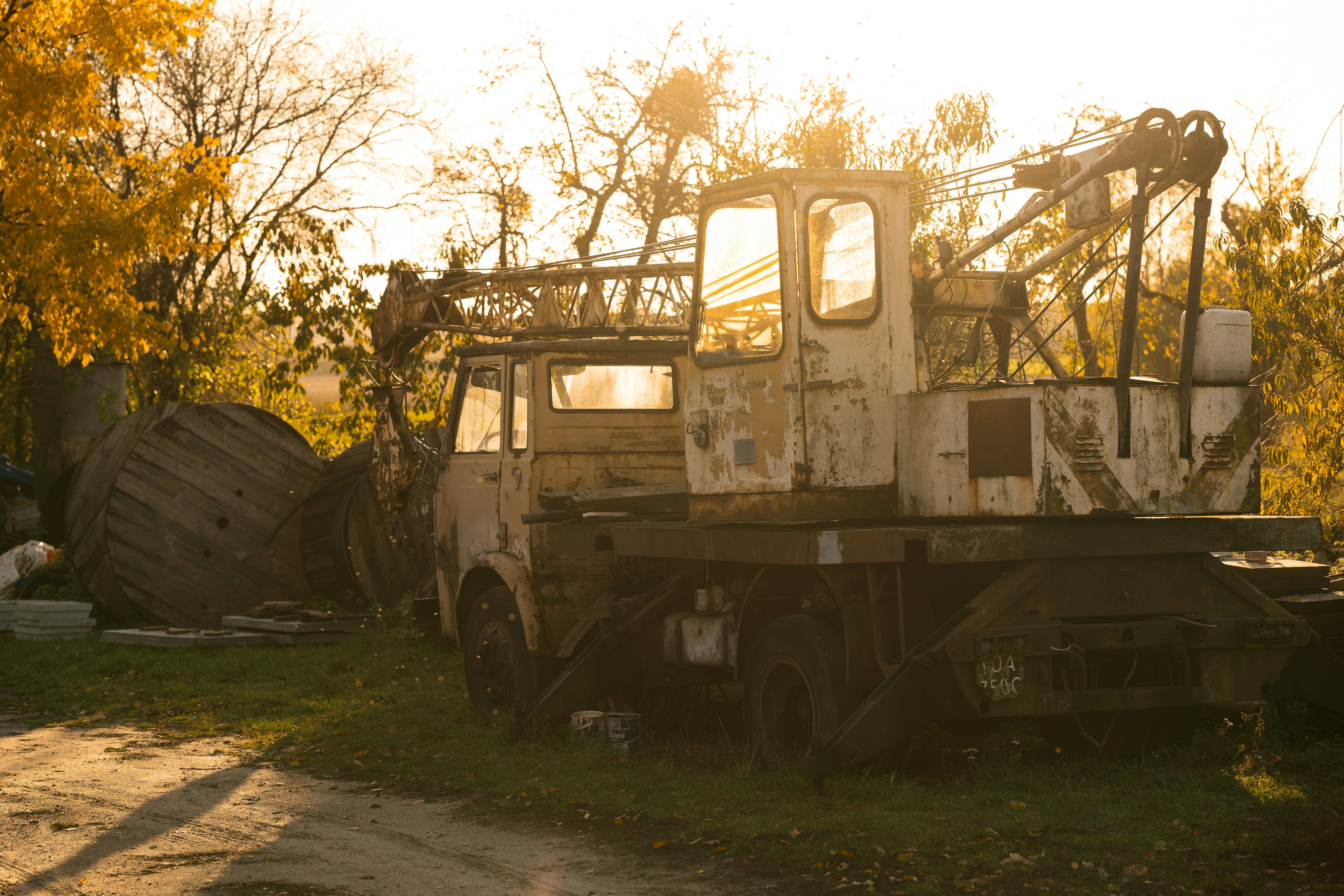 an old truck sitting in the middle of a field