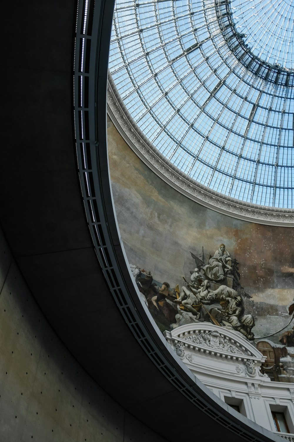 a domed glass ceiling with a painting on it