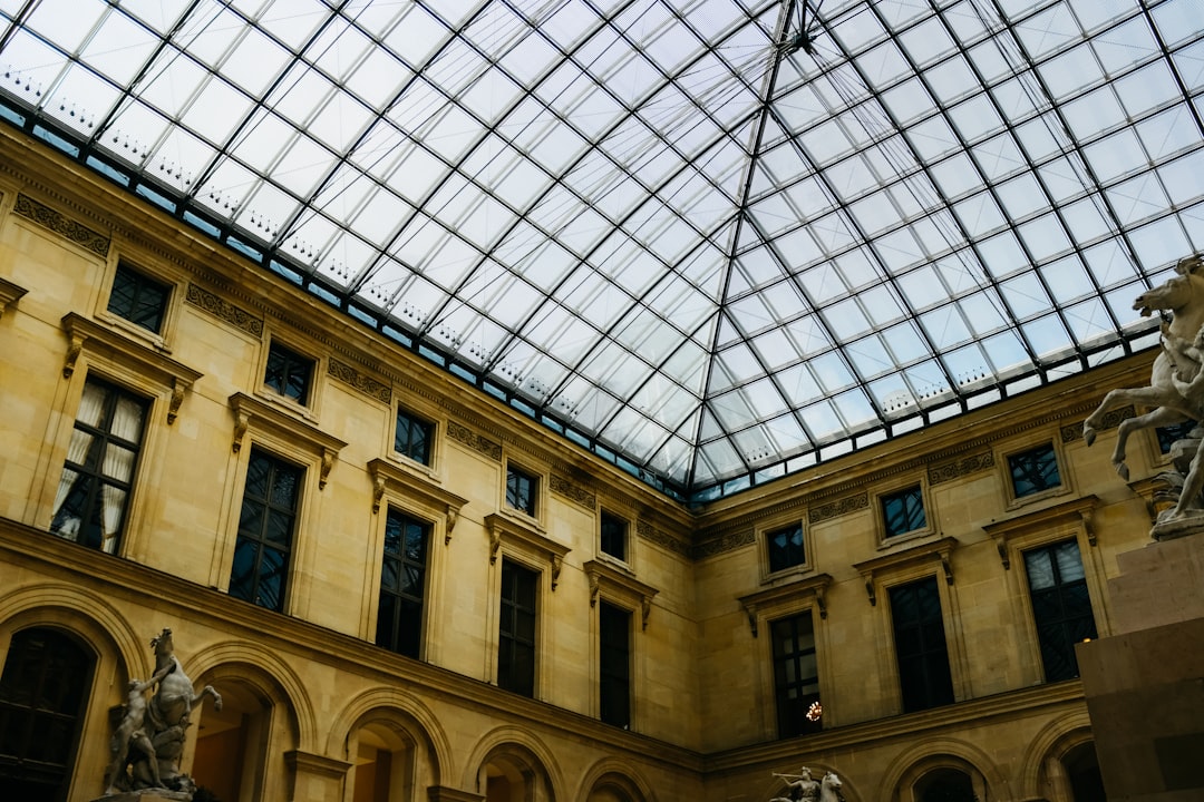 a large building with a glass ceiling and statues