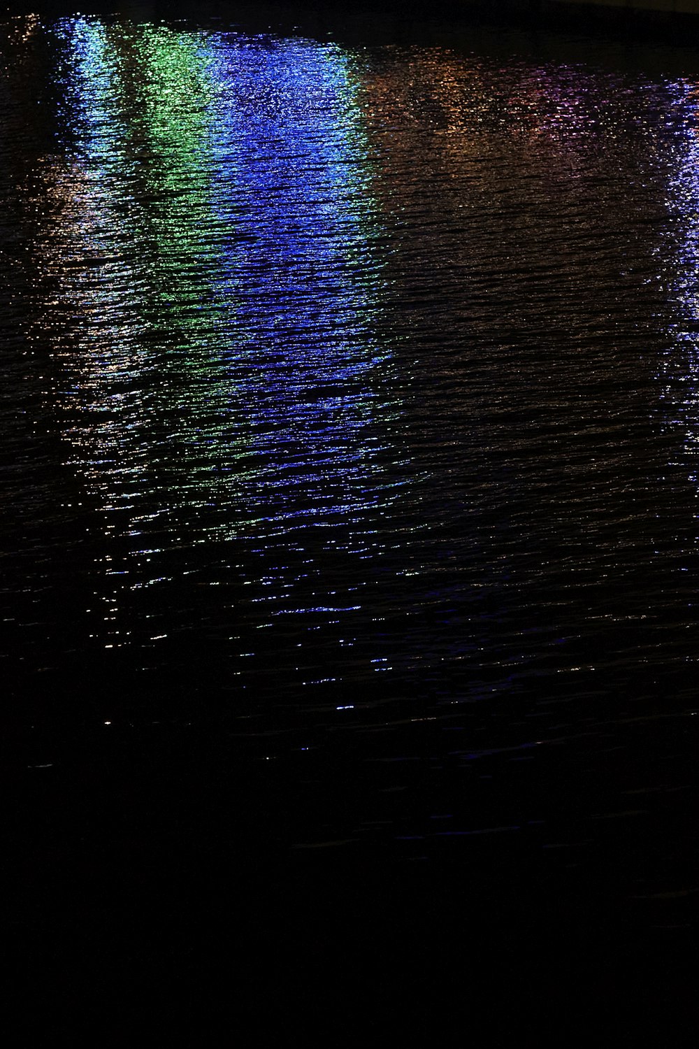 a row of lights reflecting off the water