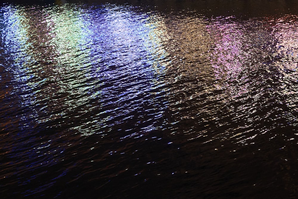 a row of lights reflecting off the water