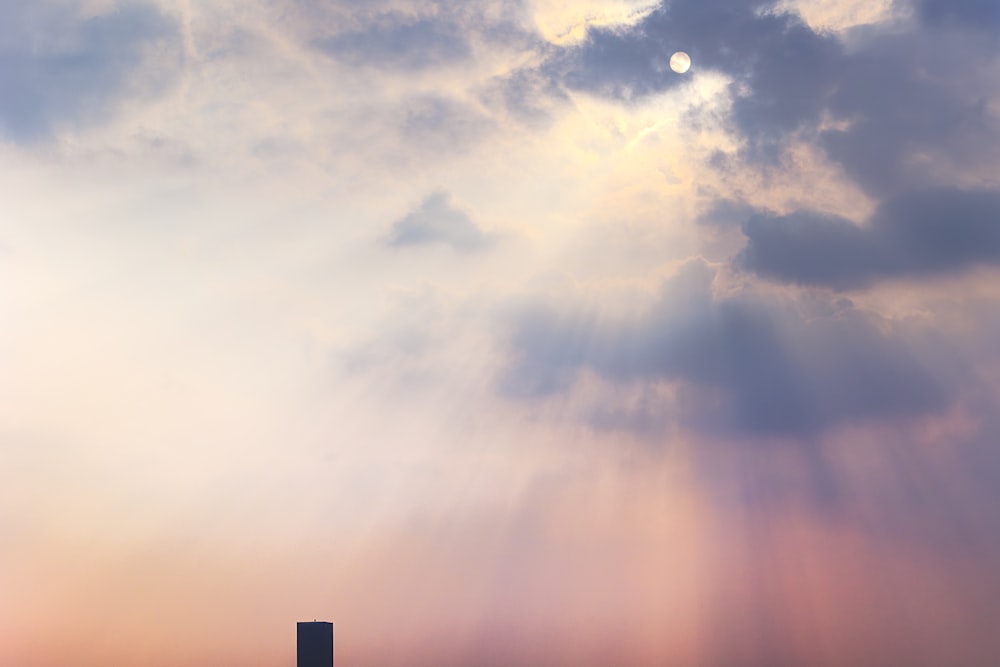 a very tall building under a cloudy sky