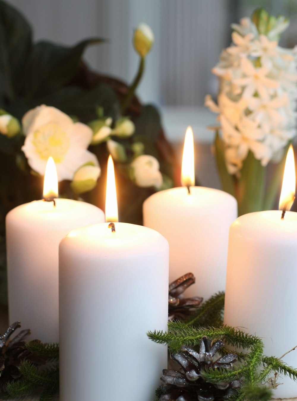 a group of white candles sitting on top of a table