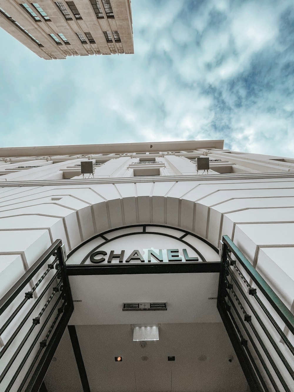 the entrance to a building with a sky background