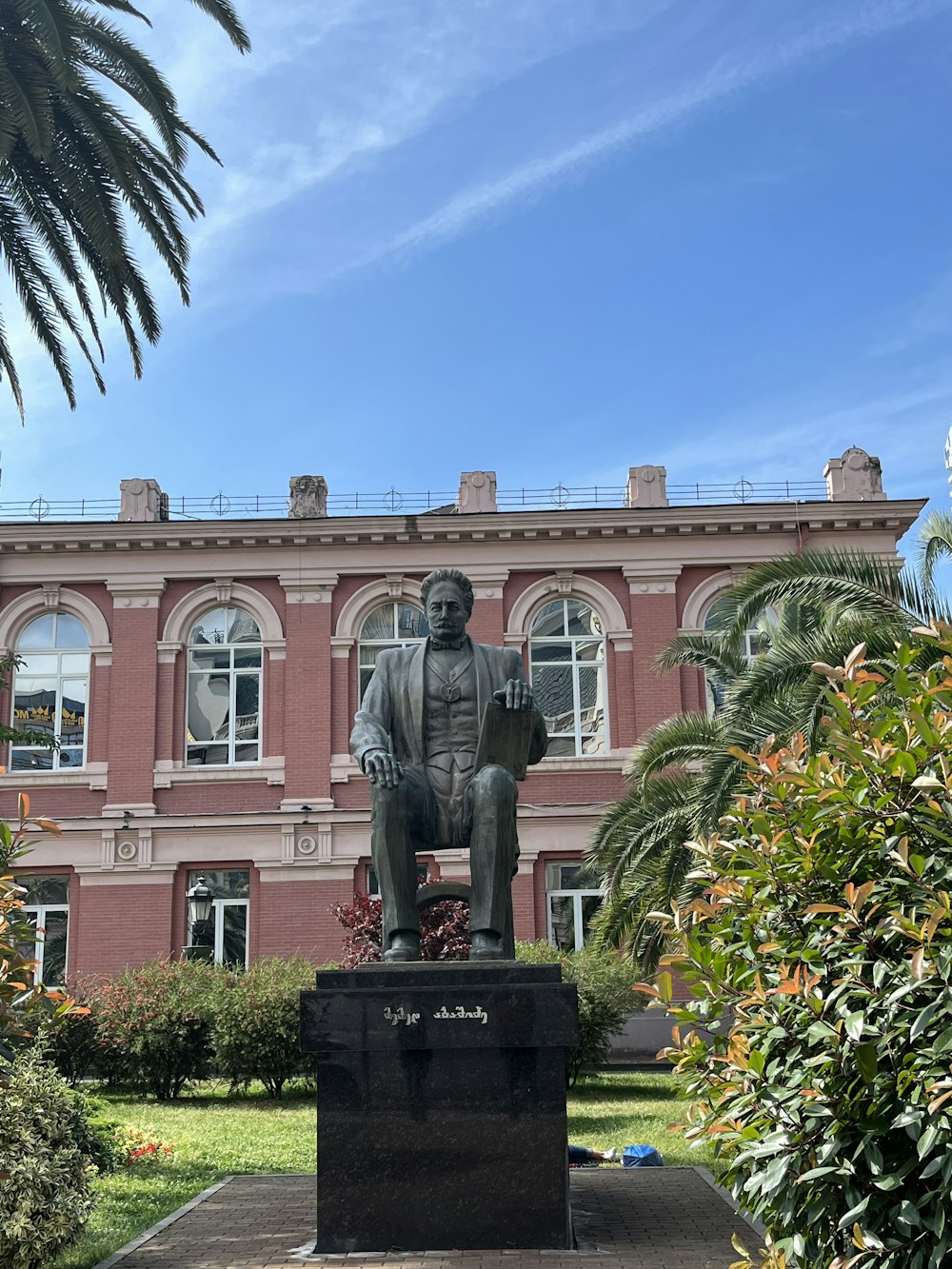 a statue of a man in front of a building