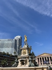 a statue of a man on a horse in front of a building