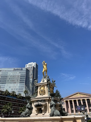 a statue of a man on a horse in front of a building