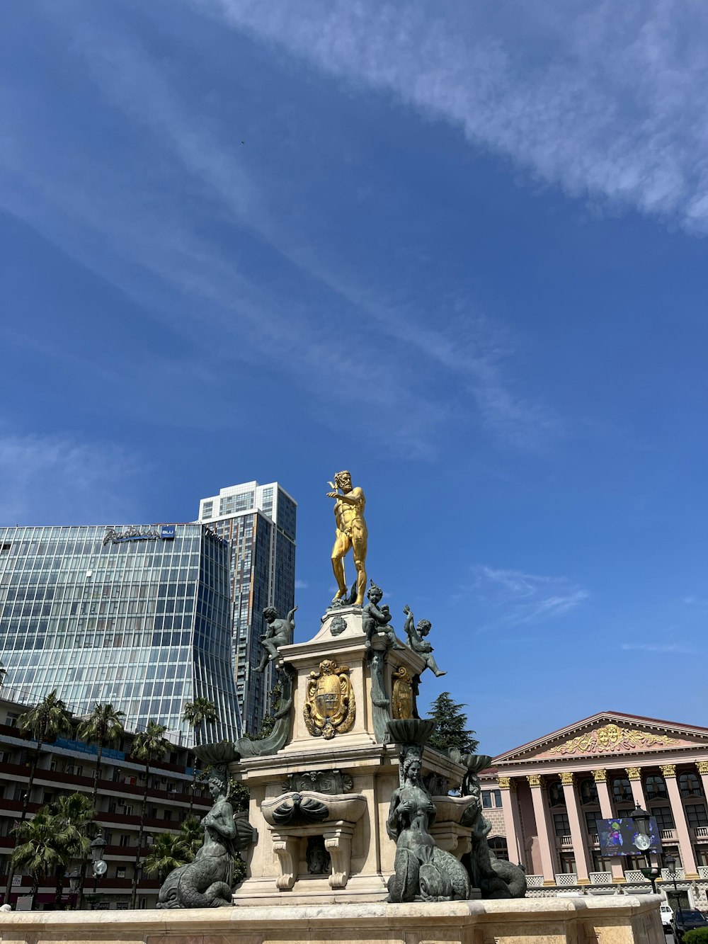 a statue of a man on a horse in front of a building